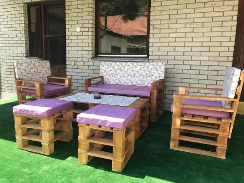 a patio with two chairs and a table and two benches at LM 19 in Novi Sad