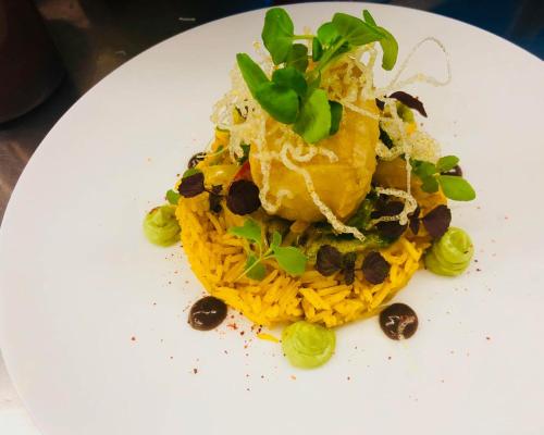 a white plate topped with food on top of pasta at Hotel Lauterbad in Freudenstadt