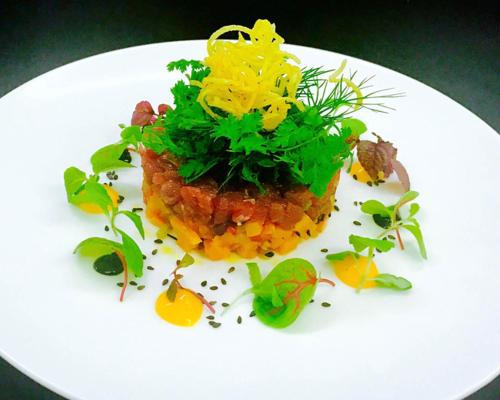a white plate with a dish of food on it at Hotel Lauterbad in Freudenstadt
