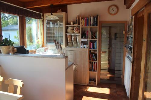a kitchen with a counter and a book shelf at Gästehaus Christa **** in Leibnitz