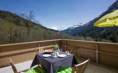 a table on a balcony with a view of mountains at Haus Natalie in Tux