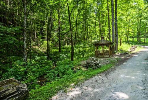 a gazebo on the side of a road in a forest at Nantahala Cabins in Bryson City