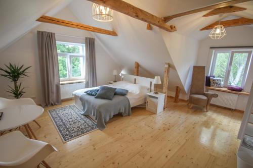 a bedroom with a bed and a table and chairs at Ligatne Homestay in Līgatne