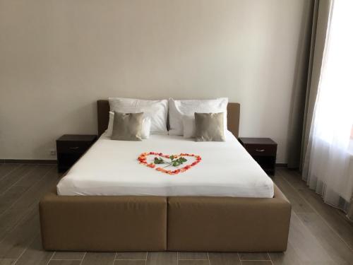 a bed with a heart made up on it at EURO APARTMENTS LIDICKÁ 39 BRNO in Brno