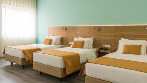 Hotel Império do Norte tesisinde bir odada yatak veya yataklar
