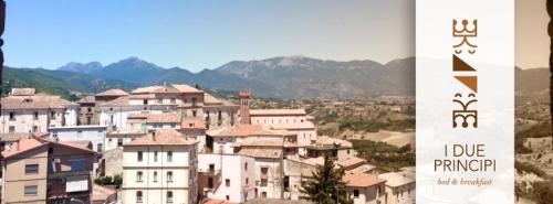 a group of buildings with mountains in the background at I Due Principi in San Marco Argentano