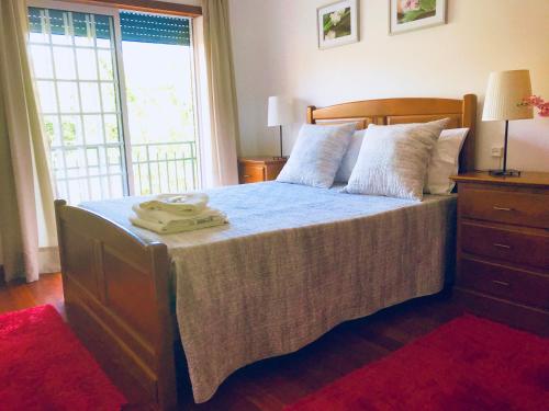 a bedroom with a bed with a blue comforter at Casa do Olival in Peso da Régua