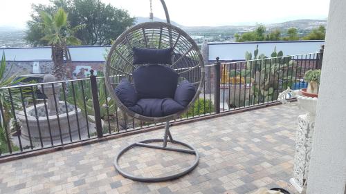 a chair sitting in a swing on a balcony at La Casona Azul Bed n Breakfast in Santa Rosa de Jáuregui
