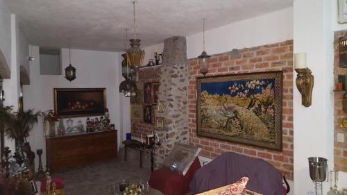 a living room with a painting on a brick wall at La Casona Azul Bed n Breakfast in Santa Rosa de Jáuregui