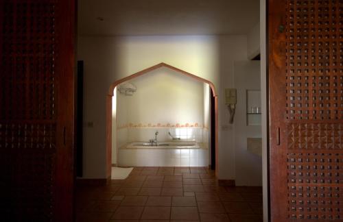 a bathroom with a sink and a mirror at Amani Beach Resort in Kutani