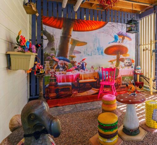 a living room with a table and a painting at CLOUD 9 - Cliff Top Eagle Heights in Mount Tamborine