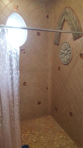 a shower with a window and a shower curtain at La Casona Azul Bed n Breakfast in Santa Rosa de Jáuregui