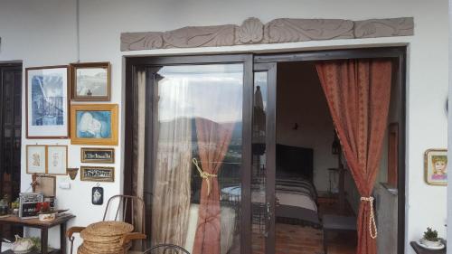 a room with a sliding glass door to a bedroom at La Casona Azul Bed n Breakfast in Santa Rosa de Jáuregui