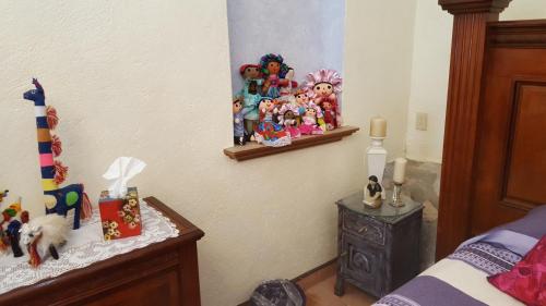 a bedroom with a bed and a table with toys on it at La Casona Azul Bed n Breakfast in Santa Rosa de Jáuregui