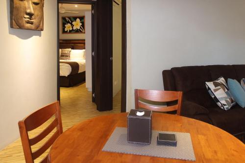 a living room with a table and a couch at GreyStone Apartments in Nadi