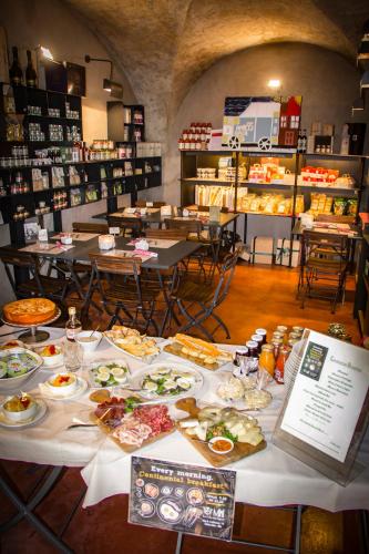 a table with plates of food on it in a store at Locanda Mimmo in Bergamo