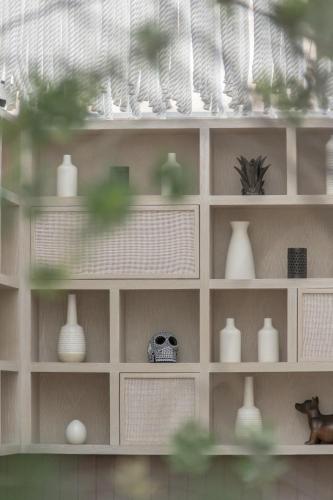 a shelf with vases and vases on it at RYO KAN Ciudad de México in Mexico City