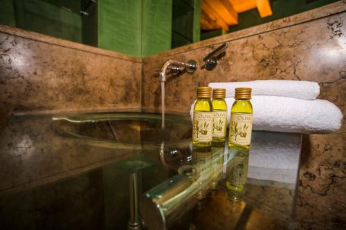 two bottles of wine sitting on a counter in a bathroom at Locanda Mimmo in Bergamo