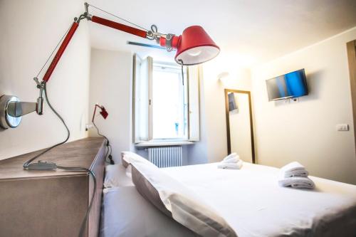 a hospital room with a bed and a lamp at Locanda Mimmo in Bergamo