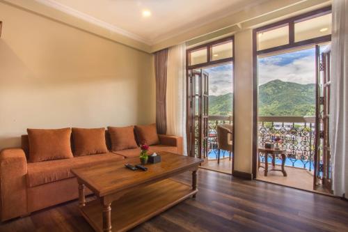 a living room with a couch and a table at Hotel Portland in Pokhara