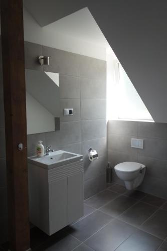 a bathroom with a white sink and a toilet at Dom Pod Siódemką in Stronie Śląskie