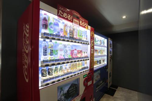 a vending machine filled with lots of drinks at Hotel Zipang in Osaka
