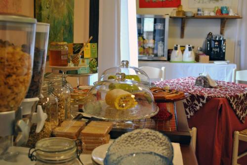 a table with a glass dish with food on it at Palazzo Bonfranceschi in Belforte del Chienti