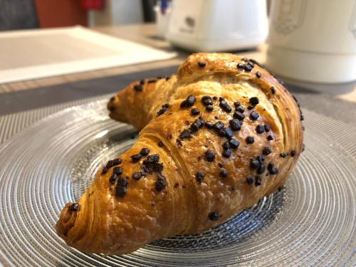 two pastries on a glass plate on a table at Hotel Brenta Milano in Milan
