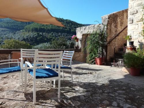 a group of chairs sitting on a patio with a view at Le Case Di S. Andrea in Buccheri