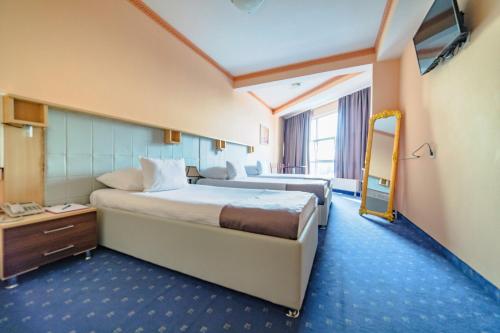 מיטה או מיטות בחדר ב-Hotel & Restaurant Great Wall