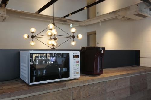 a microwave sitting on a counter in a room at Hotel Sunplaza 2 in Osaka