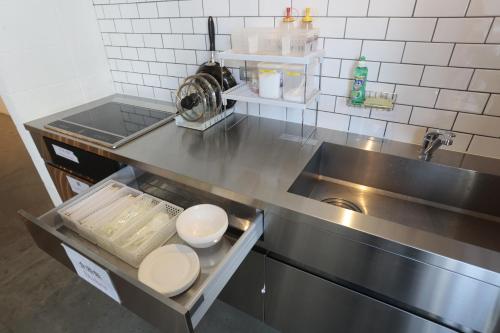 a kitchen with a sink and a counter top at Hotel Sunplaza 2 in Osaka