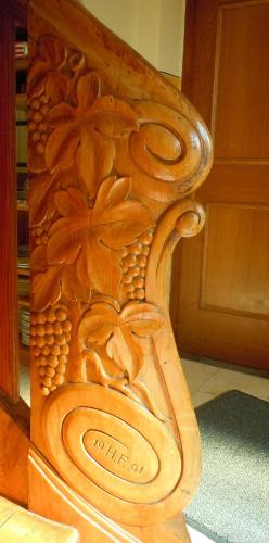 a wooden bench with a design on the side of it at Gasthaus Kirchenwirt in Koppl