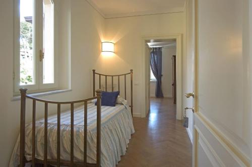 a bedroom with a bed with a lamp and a window at Villa Signori in Marina di Pietrasanta