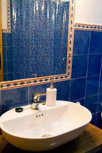 a bathroom with a white sink and a mirror at Casa rural La Rasa in Cabezas Altas