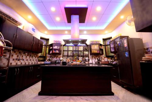 a kitchen with a bar in the middle of it at Aman Homestay, A Boutique Hotel in Agra
