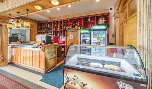 a restaurant with a food counter and a display case at Hotel & Restaurant Great Wall - Airport in Sarajevo