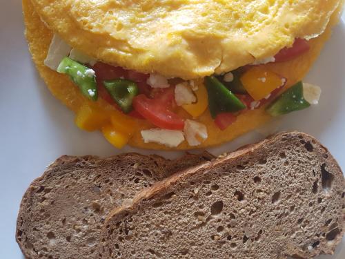 a sandwich on a plate with a slice of bread at VN Guesthouse in Kanchanaburi