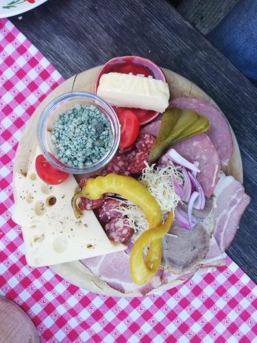 a plate of food with meat and vegetables on a table at Appartement Sonnblick Kuschelsuite in den Bergen in Großsölk