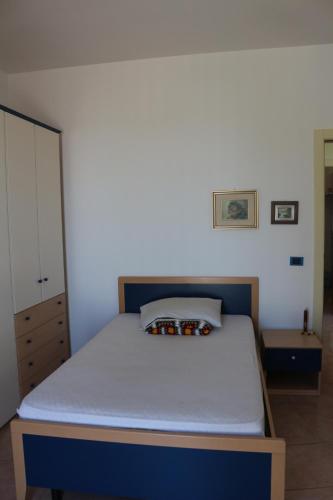 a bedroom with a bed with a blue and white mattress at B&B Belvedere in Cassano delle Murge