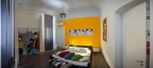 a bedroom with a bed and a yellow wall at Palermo Gallery in Palermo