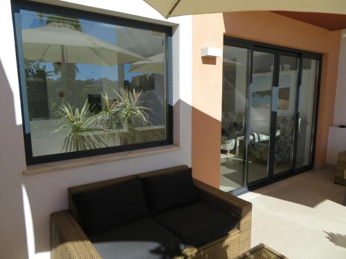 a living room with a couch and a large window at Hotel Alcaide in Portimão