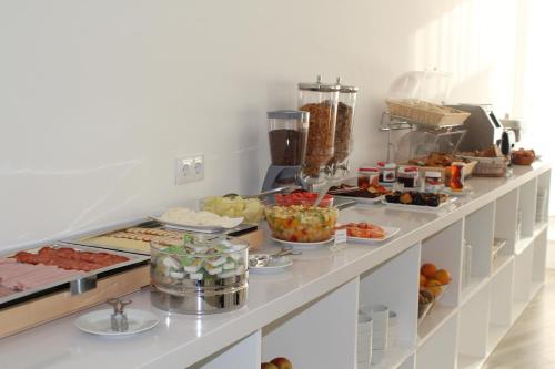 a buffet line with many different types of food at Hotel Alcaide in Portimão