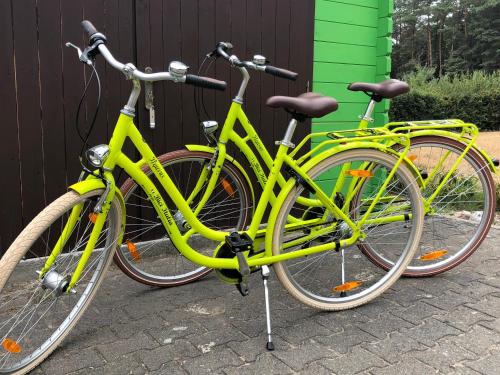 two yellow bikes parked next to a building at Hotel Tau-Lünne in Haselünne