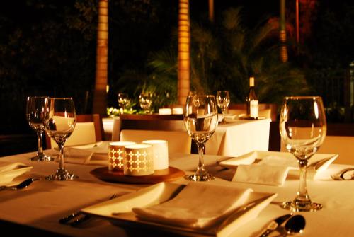 a table with wine glasses and napkins on it at Provident Doral At The Blue in Miami