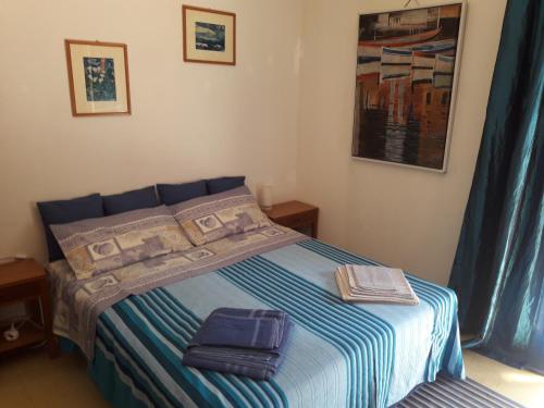 a bedroom with a bed with two bags on it at Appartamento MiMa Pineta in Milano Marittima