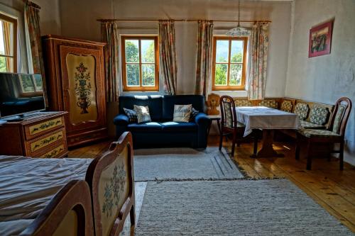 a living room with a couch and a table at Pension Eckschlager in Lofer