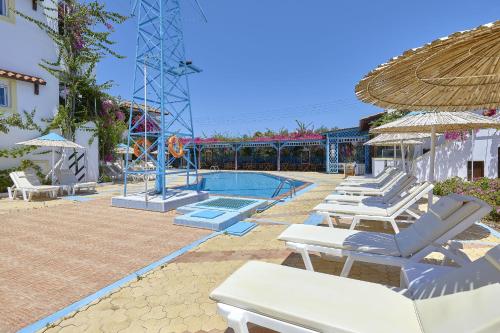 a group of lounge chairs and a swimming pool at Paul Marie in Hersonissos