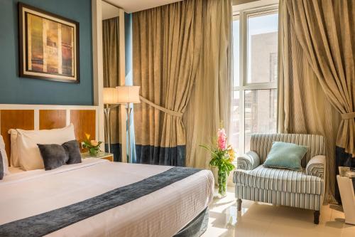 a bedroom with a bed and a chair and a window at Al Muhaidb Residence Al Malaz 2 - Economic in Riyadh