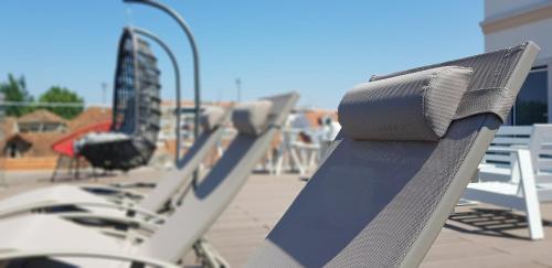 a row of white chairs and a playground at Thomar Boutique Hotel in Tomar